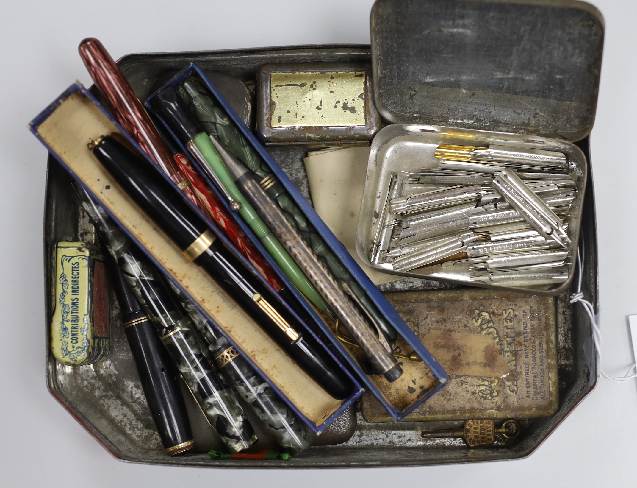 A collection of gold nibbed fountain pens and a collection of nibs